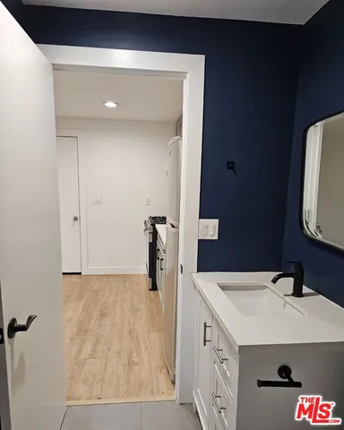 a bathroom with a sink toilet and mirror