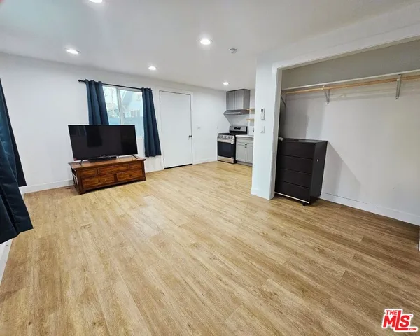 a view of kitchen with refrigerator and microwave