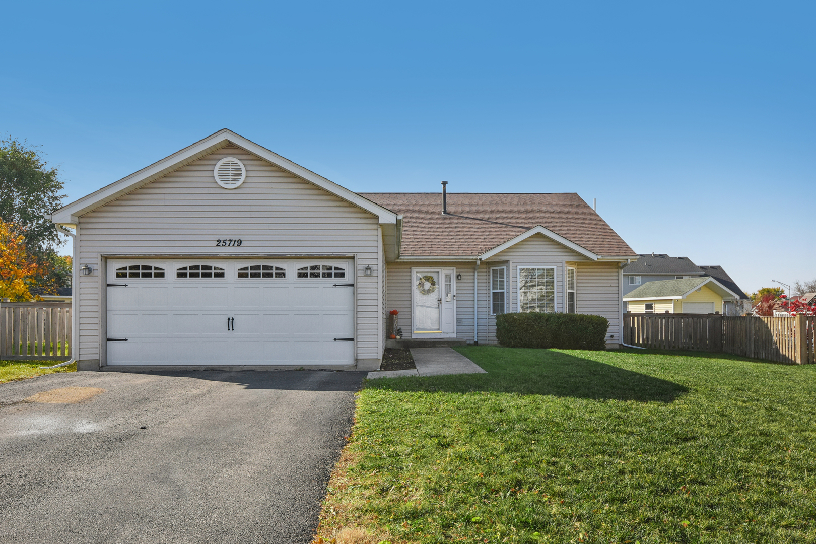 a view of a house with a yard and garage