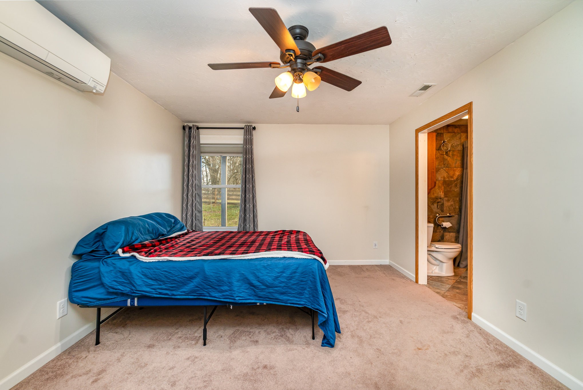 6960 Highway 231 Bethpage, TN 37022 - Photo 16 of 32 a bed sitting in a bedroom next to a window