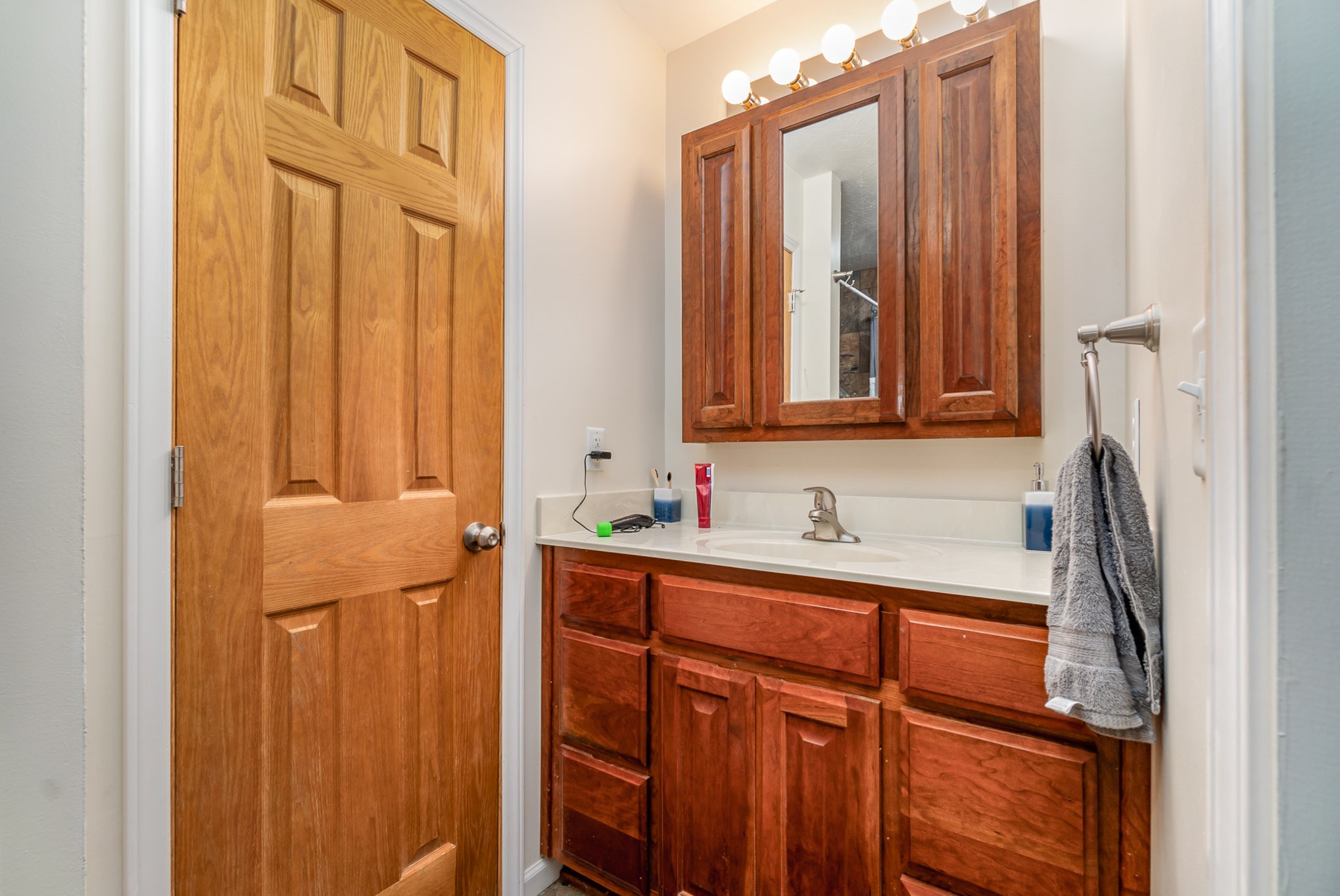 6960 Highway 231 Bethpage, TN 37022 - Photo 18 of 32 a bathroom with a sink a mirror and a shower