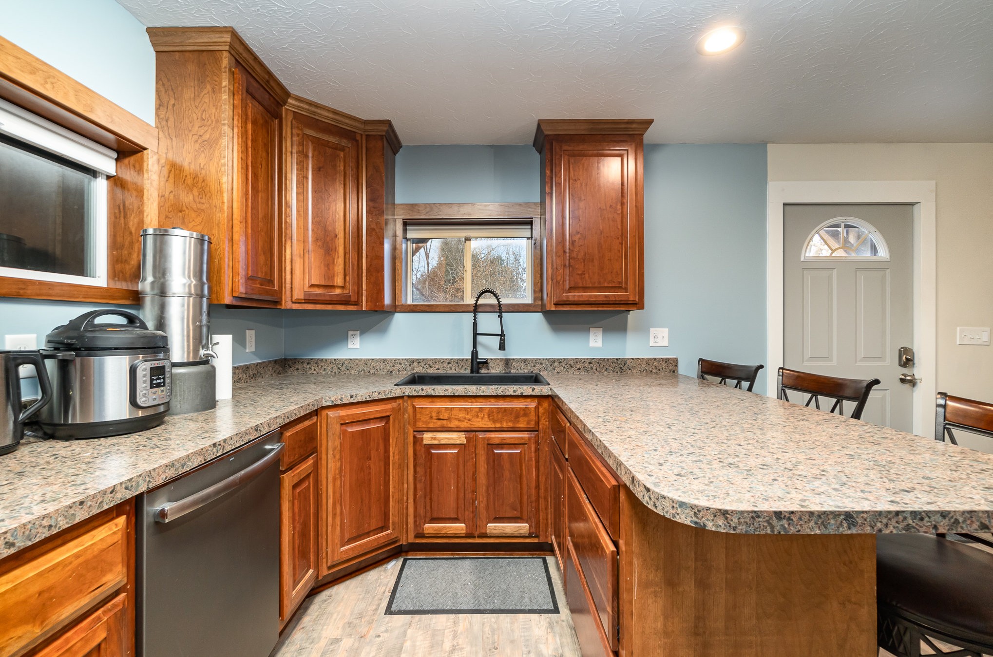 6960 Highway 231 Bethpage, TN 37022 - Photo 7 of 32 a kitchen with granite countertop a sink a counter top space cabinets and stainless steel appliances