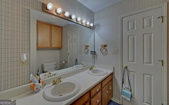 a bathroom with a sink a vanity and a mirror