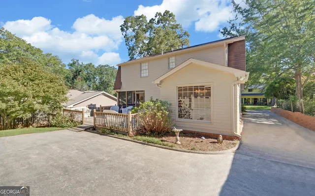a view of a white house with a yard and garage