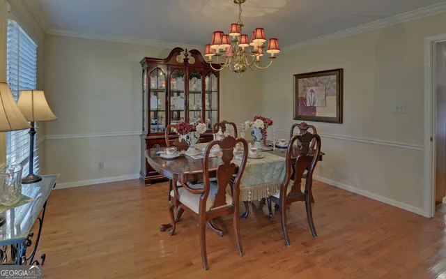 a dining room with furniture and chandelier