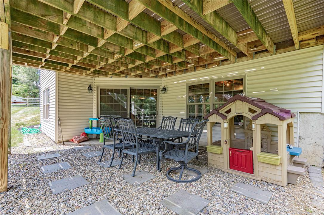 6000 Pond View Terrace Bath, PA 18014 - Photo 55 of 69 An inviting gravel patio beneath a spacious deck offers an ideal spot for outdoor gatherings.