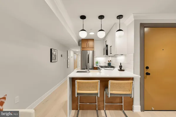 a kitchen with a table and chairs in it