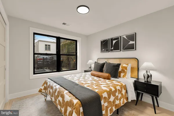 a bedroom with a bed and a window
