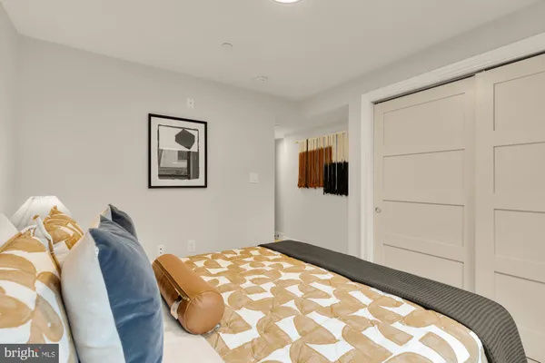 a bedroom with a bed and a painting on the wall