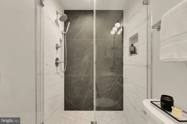 a bathroom with a shower and a sink