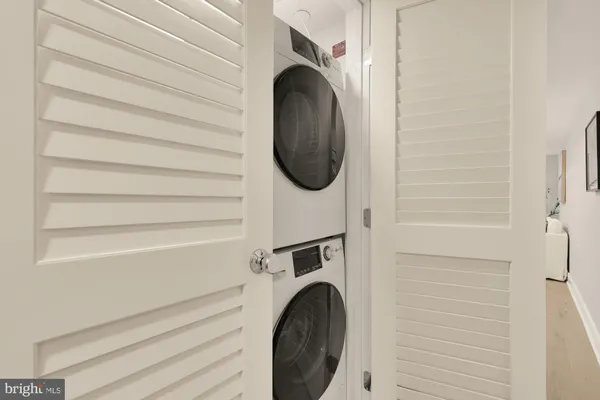 a close view of a utility room with dryer and washer