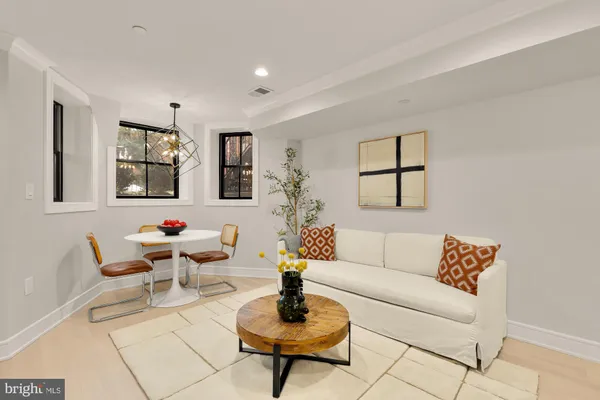 a living room with furniture and a potted plant