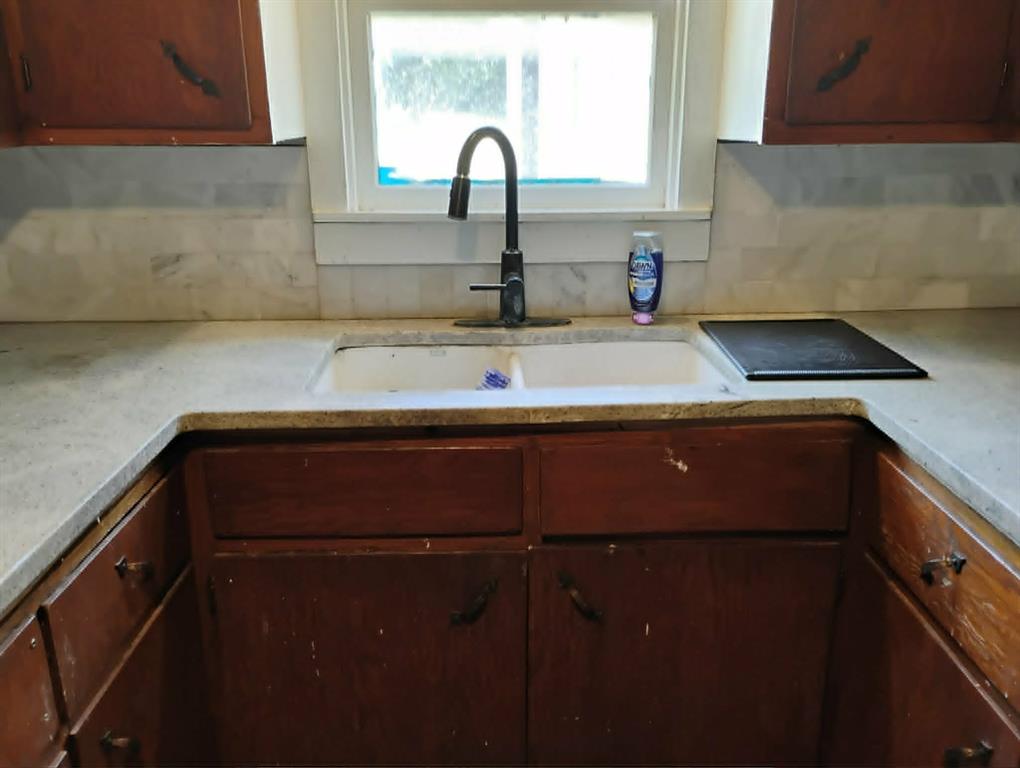 763 Frontier Street Bowie, TX 76230 - Photo 5 of 28 a kitchen with a sink and a window