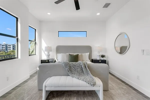 a bedroom with a large bed and a couch