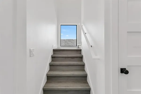 a view of staircase with white walls