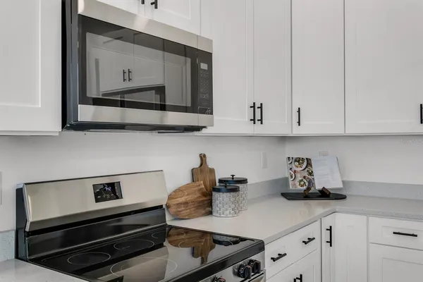 a kitchen with appliances cabinets and a counter top space