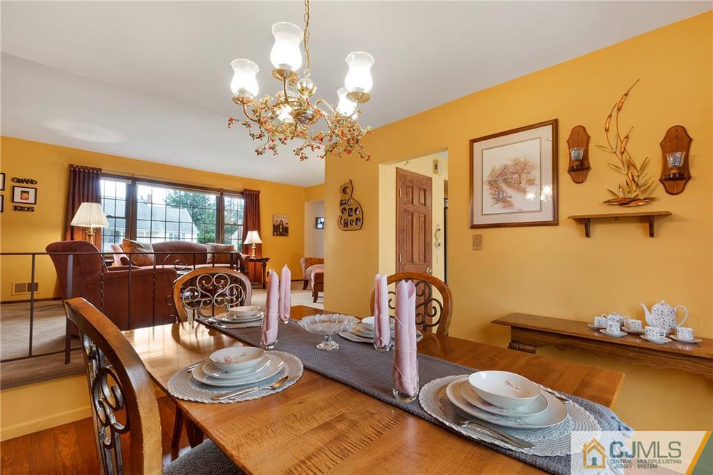 23 Roxy Avenue Edison, NJ 08820 - Photo 2 of 24 a very nice looking dining room with furniture a chandelier and wooden floor