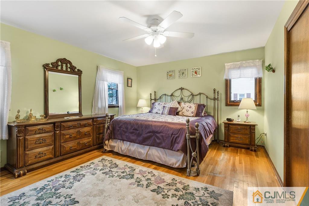 23 Roxy Avenue Edison, NJ 08820 - Photo 12 of 24 a bedroom with a bed and wooden floor
