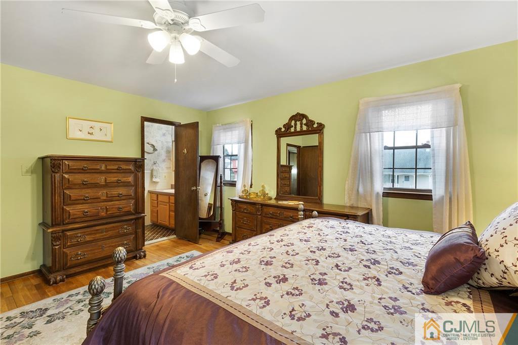 23 Roxy Avenue Edison, NJ 08820 - Photo 13 of 24 a bedroom with a bed and a chandelier