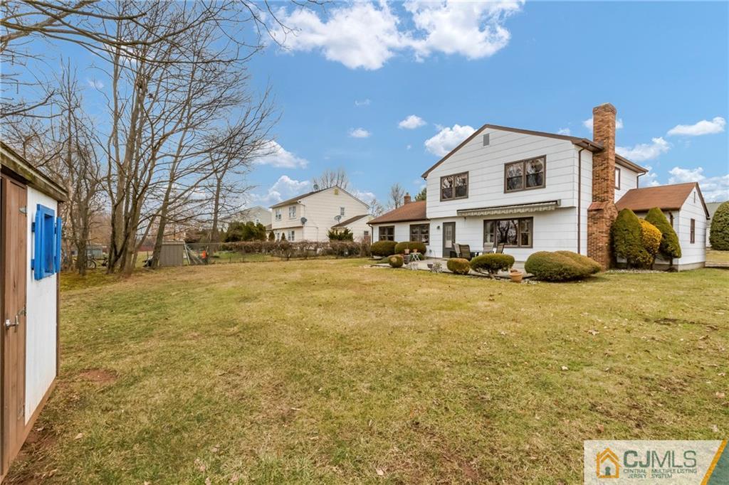 23 Roxy Avenue Edison, NJ 08820 - Photo 21 of 24 a view of a white house with a yard