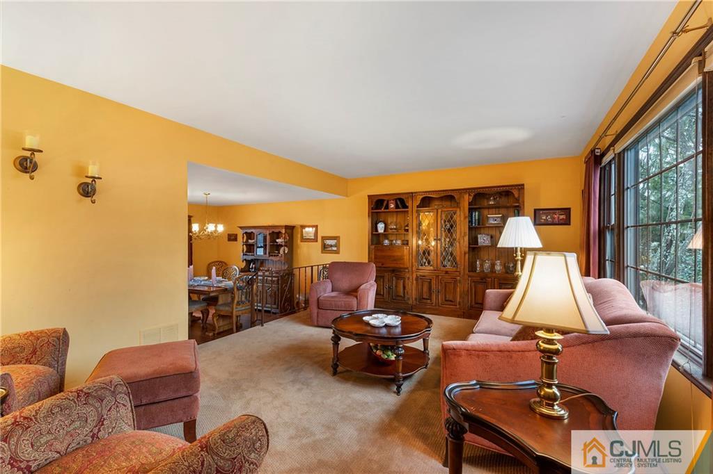 23 Roxy Avenue Edison, NJ 08820 - Photo 4 of 24 a living room with furniture a rug and a floor to ceiling window