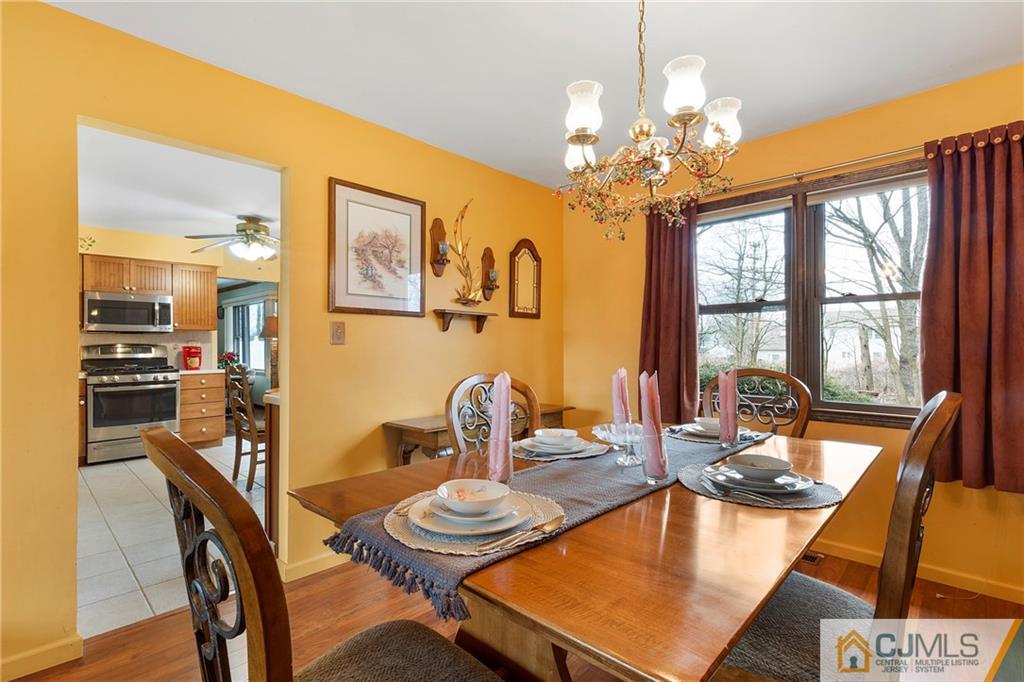 23 Roxy Avenue Edison, NJ 08820 - Photo 5 of 24 a dining room with furniture and a chandelier