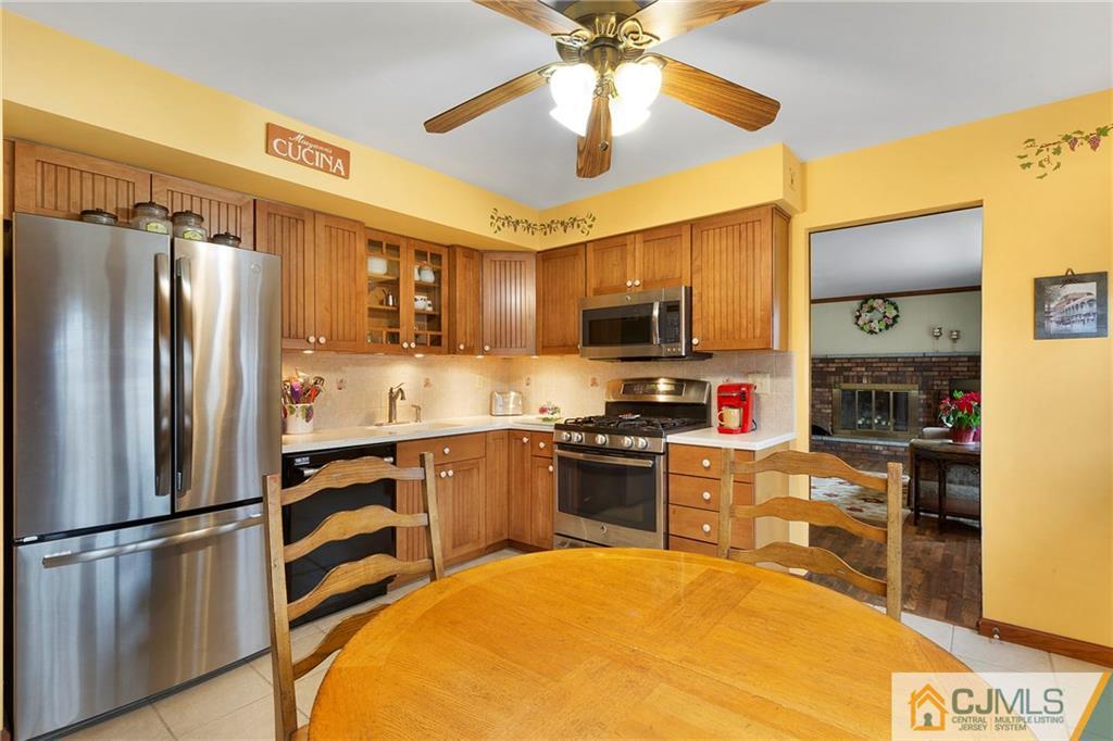 23 Roxy Avenue Edison, NJ 08820 - Photo 8 of 24 a kitchen with stainless steel appliances granite countertop a refrigerator stove microwave and sink