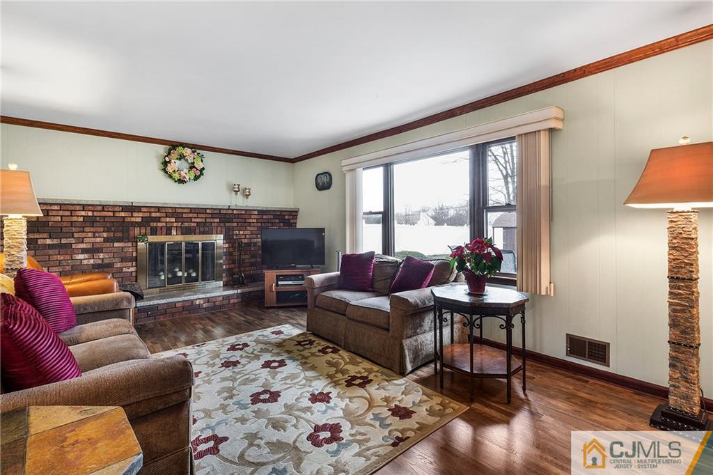 23 Roxy Avenue Edison, NJ 08820 - Photo 9 of 24 a living room with furniture and a fireplace