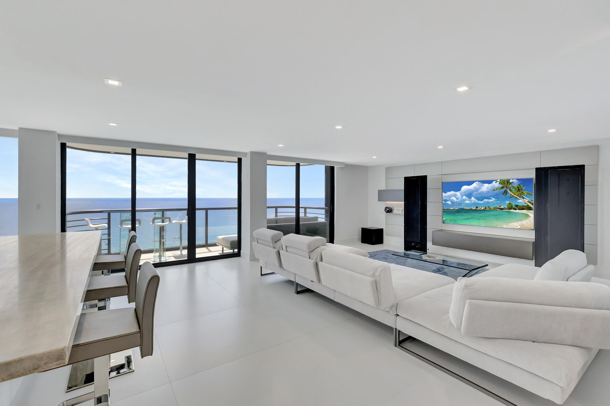 250 South Ocean Boulevard, Unit 16G Boca Raton, FL 33432 - Photo 1 of 91 a living room with furniture large windows and a flat screen tv