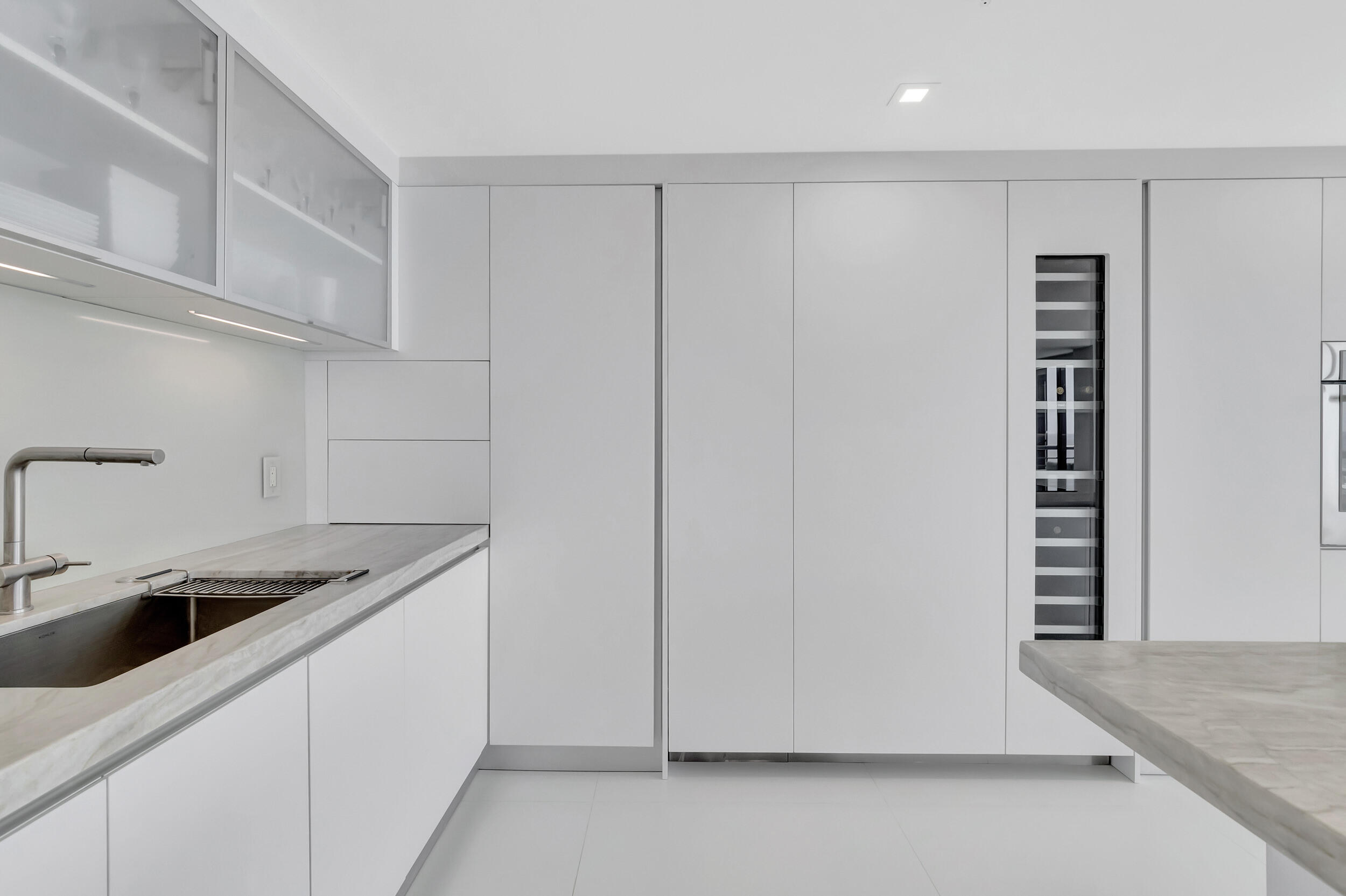 250 South Ocean Boulevard, Unit 16G Boca Raton, FL 33432 - Photo 30 of 91 a kitchen with a sink and cabinets