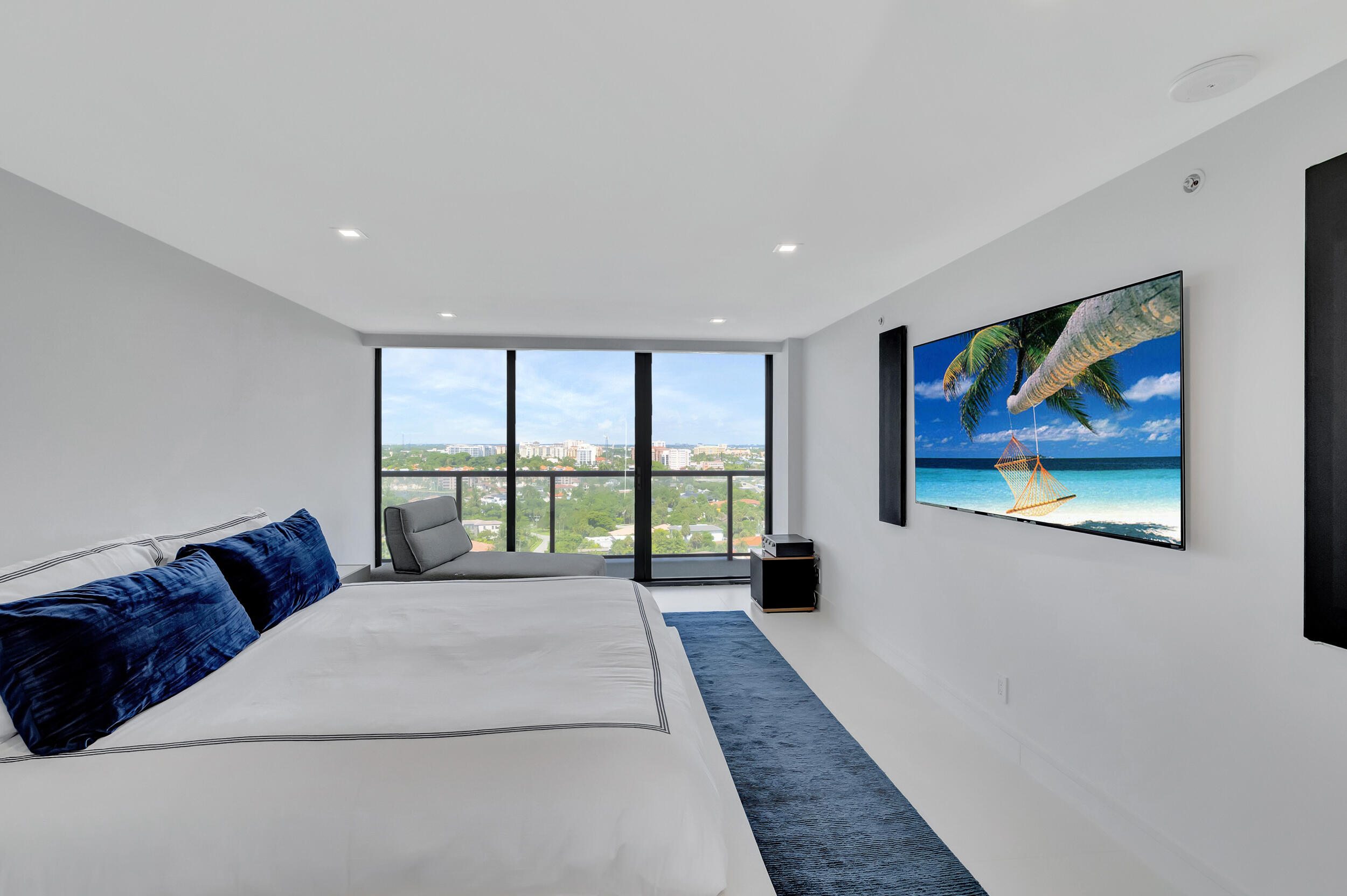 250 South Ocean Boulevard, Unit 16G Boca Raton, FL 33432 - Photo 45 of 91 a large white bed sitting in a room next to a window