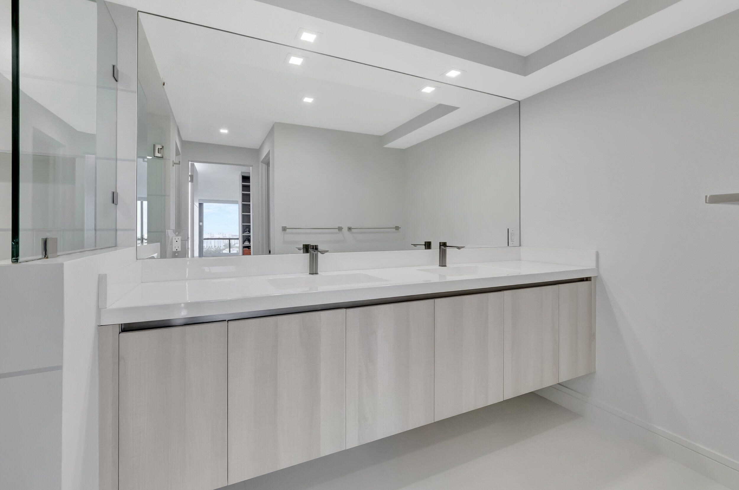 250 South Ocean Boulevard, Unit 16G Boca Raton, FL 33432 - Photo 49 of 91 a bathroom with a double vanity sink and a mirror