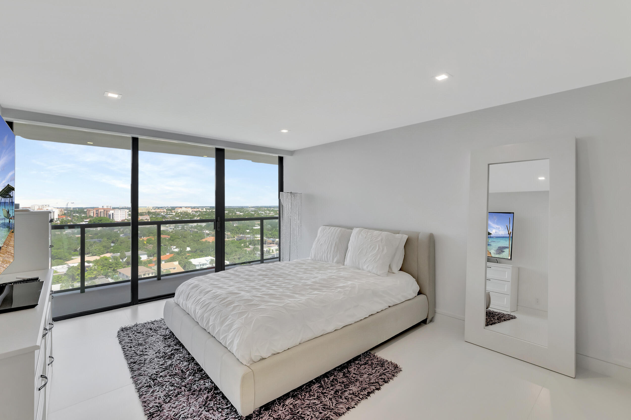 250 South Ocean Boulevard, Unit 16G Boca Raton, FL 33432 - Photo 58 of 91 a bedroom with a large bed and a large window