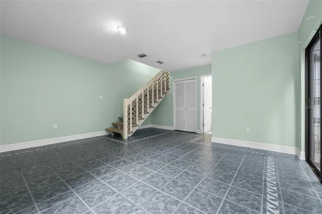 a view of an empty room with stairs