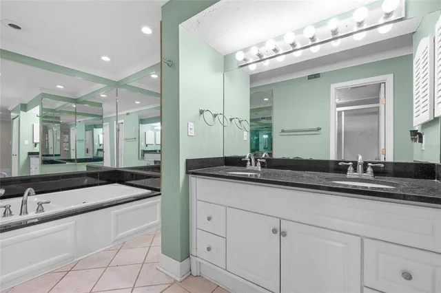 a spacious bathroom with a granite countertop sink a mirror and a