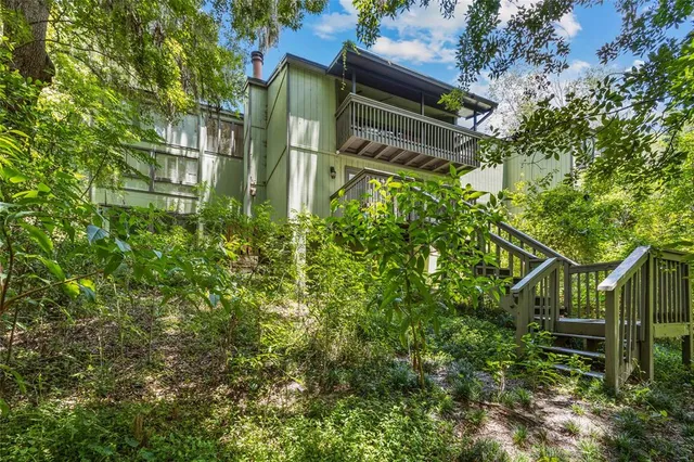a backyard of a house with lots of green space and a fountain