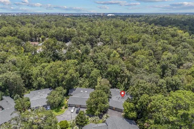 an aerial view of a house with a yard