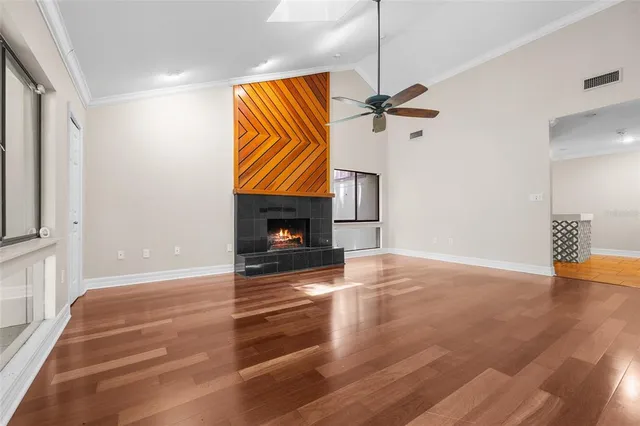 a view of empty room with fireplace and fan
