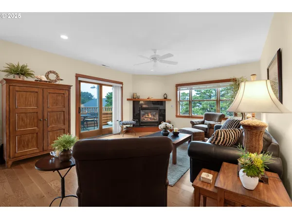 a living room with fireplace furniture and a large window