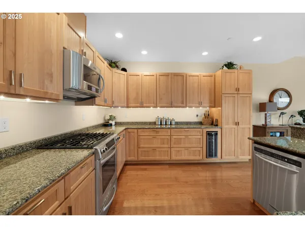 a kitchen with granite countertop a stove top oven sink and cabinets