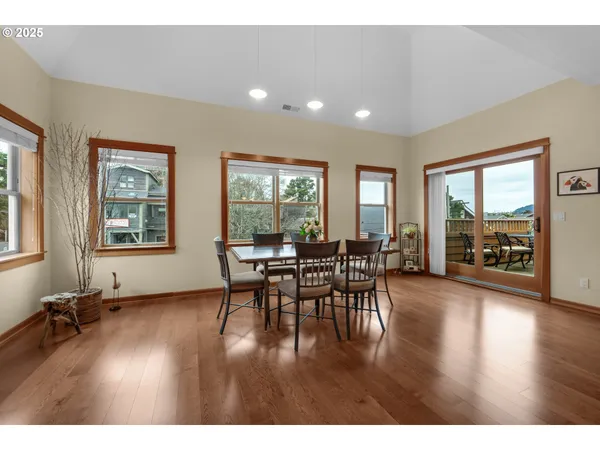 a dining room with furniture and wooden floor