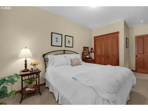 a bedroom with a bed and a night stand