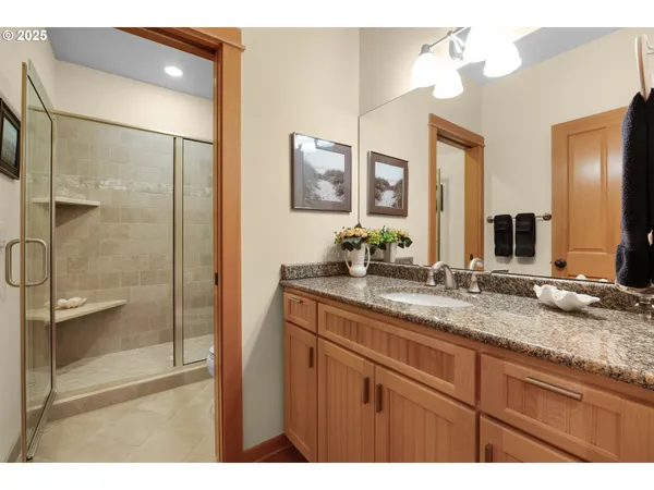 a bathroom with a granite countertop sink mirror and double