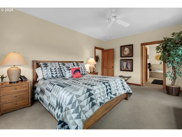 a bedroom with a large bed and a chandelier