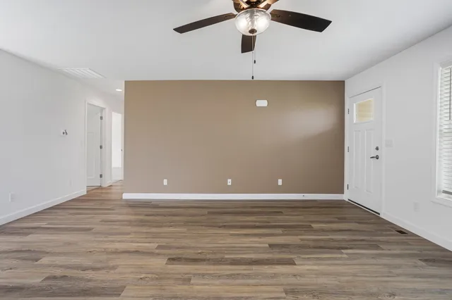 wooden floor in an empty room with a window