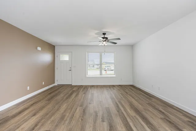 a kitchen with kitchen island wooden floors and stainless steel appliances