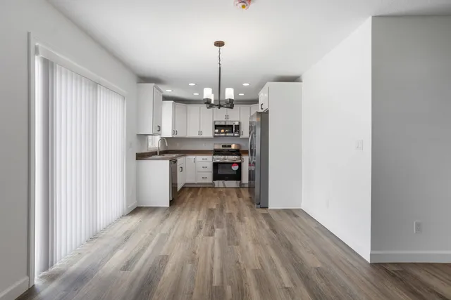 a kitchen with stainless steel appliances a refrigerator sink and microwave