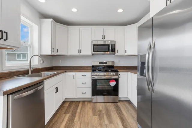 a kitchen with granite countertop a sink and cabinets