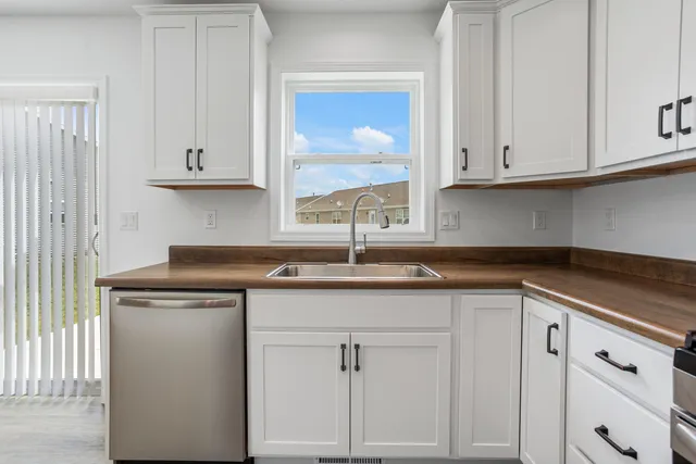 a kitchen with cabinets and a stove top oven