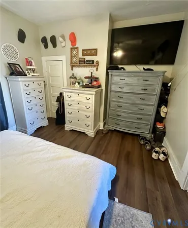 a bed room with a bed and a television